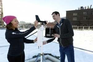 The Weather Company Meteorologist, Jess Parker (left) works with IBM Watson Developer Chris Ackerson (right) to install a personal weather station on the roof of IBM Watson Headquarters at Astor Place in New York City. IBM today announced that it has closed the acquisition of The Weather Company's B2B, mobile and cloud-based web-properties, weather.com, Weather Underground, The Weather Company brand and WSI, its global business-to-business brand. (Jon Simon/Feature Photo Service for IBM)